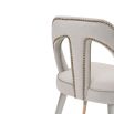 A luxury dining chair by Liang & Eimil with a gorgeous grey upholstery and brass detailing