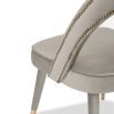 A luxury dining chair by Liang & Eimil with a gorgeous grey upholstery and brass detailing