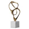 Swirling brass structure sculpture on white marble base