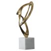 Swirling brass structure sculpture on white marble base