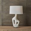 Ivory man-made stone lamp resting on simple antique brass base