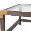 A stylish coffee table by Theodore Alexander with brushed brass corners