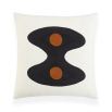 White cushion with black wavy shape and two orange circles