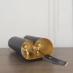 A chic black and gold wall lamp