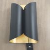 A chic black and gold wall lamp