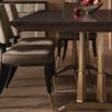 Extendable dining table with brass base and sleek brown tabletop