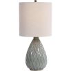 This ceramic table lamp features a textured rust and aqua pattern, brushed nickel accents, and a beige linen shade