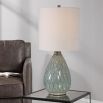 This ceramic table lamp features a textured rust and aqua pattern, brushed nickel accents, and a beige linen shade