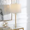 This table lamp features a gold leaf finish, stacked hourglass design, crystal base, and an ivory linen shade, exuding elegance and timeless sophistication. Sold as a set of two.