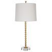 This table lamp features a gold leaf finish, stacked hourglass design, crystal base, and an ivory linen shade, exuding elegance and timeless sophistication. Sold as a set of two.