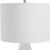 This ceramic lamp features a textured satin white finish, brushed nickel accents, and a white linen shade, adding elegance and simplicity to any room.