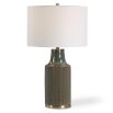 This ceramic table lamp features a bluish-green finish with rust undertones, brushed brass accents, and a white linen shade, adding sophisticated charm to any space.