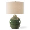 This elegant ceramic lamp has a moss green glaze, brass accents, and a beige linen shade.