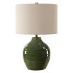 This elegant ceramic lamp has a moss green glaze, brass accents, and a beige linen shade.