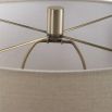 This elegant ceramic lamp has a moss green glaze, brass accents, and a beige linen shade.