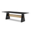 A statement dining table by Liang & Eimil with a black and brass finish