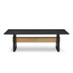 A statement dining table by Liang & Eimil with a black and brass finish