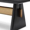 A statement dining table by Liang & Eimil with a black and brass finish