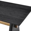 A statement dining table by Liang & Eimil with a black and brass finish