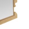 Textural gold mirror reminiscent of a puzzle shape 