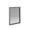 Delicate mosaic of black and white resin adorn a rectangular mirror